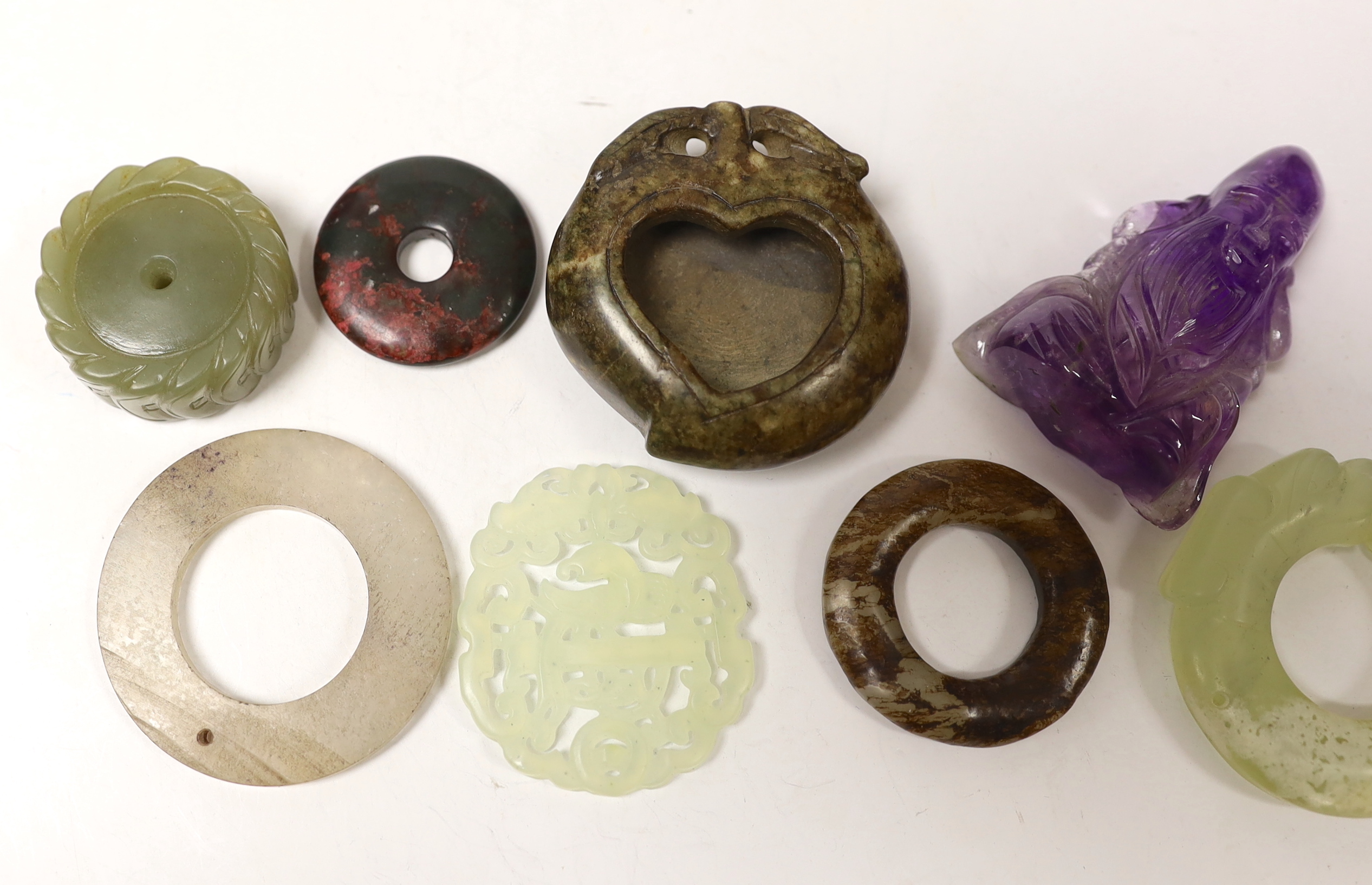 Eight Chinese jade or hardstone carvings including discs, largest 6cm in diameter